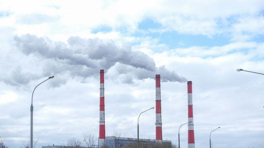 Modern large thermal power plant.Smoke from heating station in big city Smokestack pipes emitting co