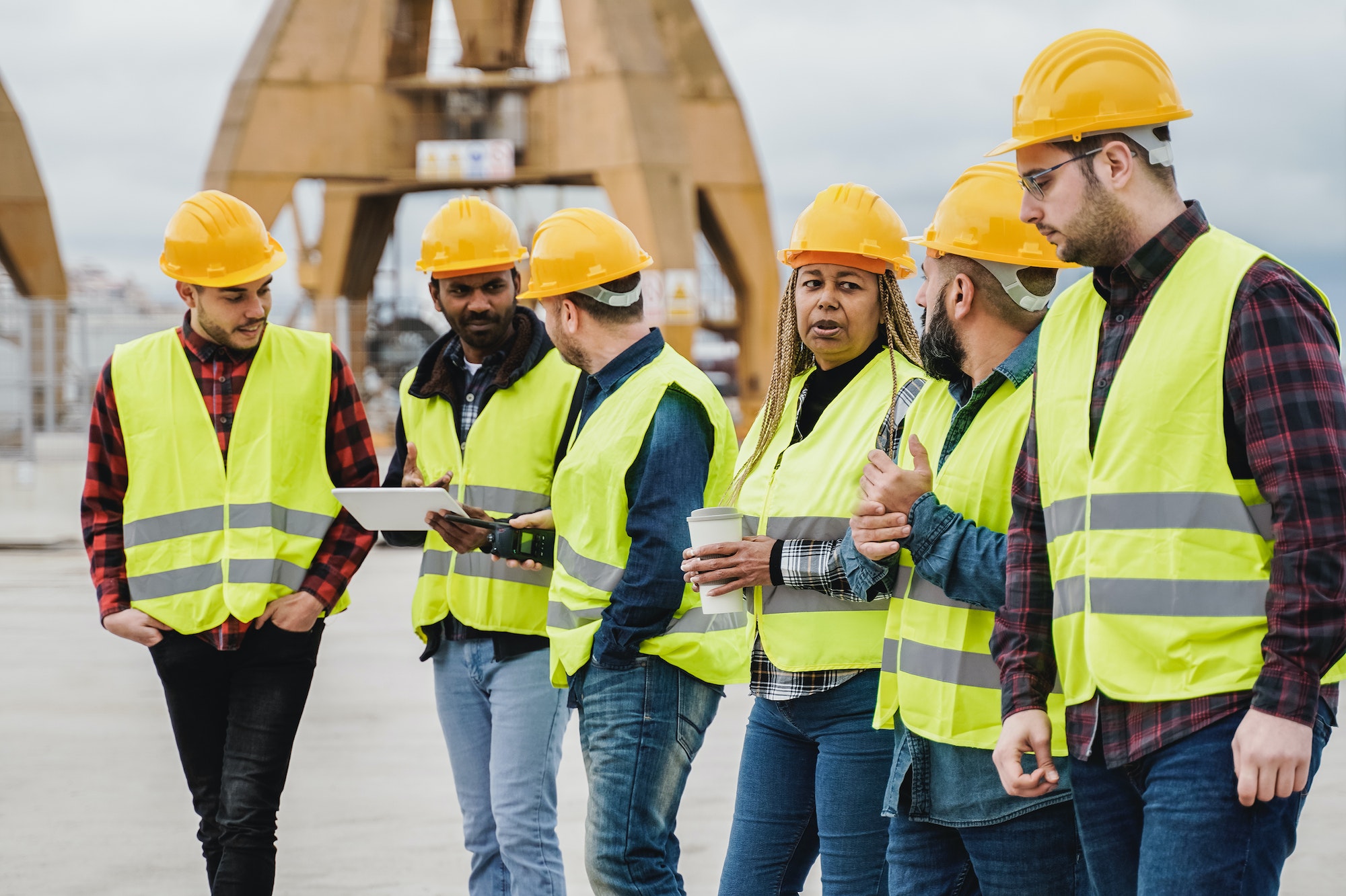 Multiracial people working at industrial construction site outdoor - Focus on african senior face