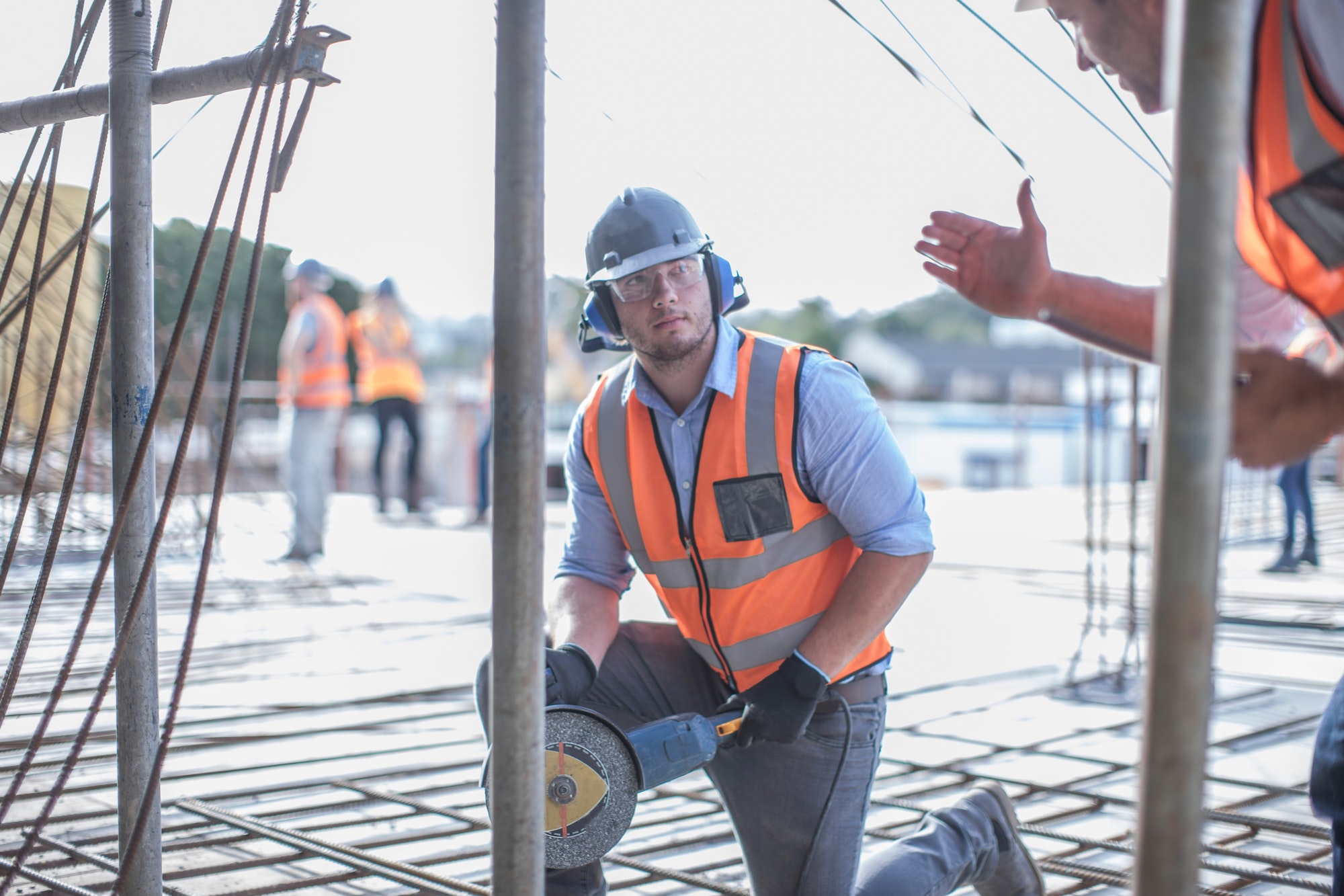 Site manager explaining to builder on construction site